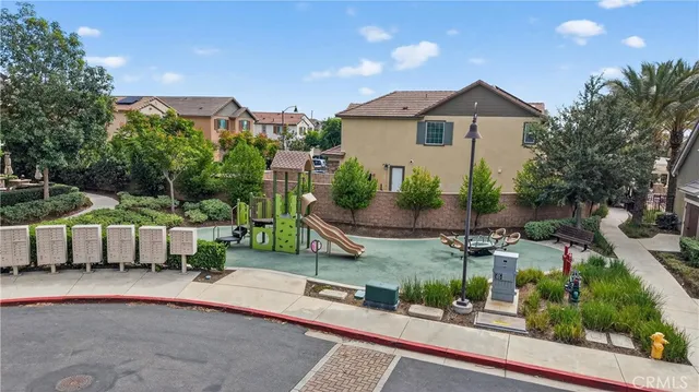 a view of a house with a yard and sitting area