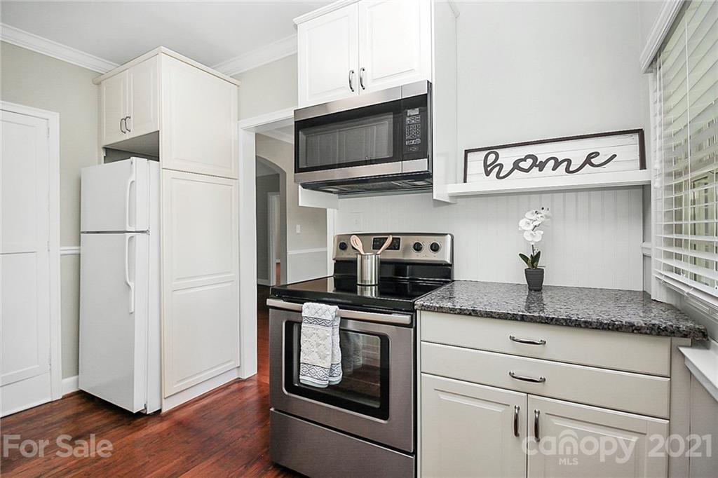 930 Ardsley Road, Unit B4 Charlotte, NC 28207 - Photo 24 of 35 a kitchen with stainless steel appliances granite countertop a refrigerator and a stove top oven