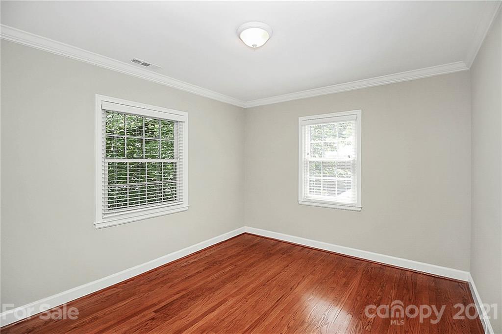 930 Ardsley Road, Unit B4 Charlotte, NC 28207 - Photo 26 of 35 a view of an empty room with wooden floor and a window