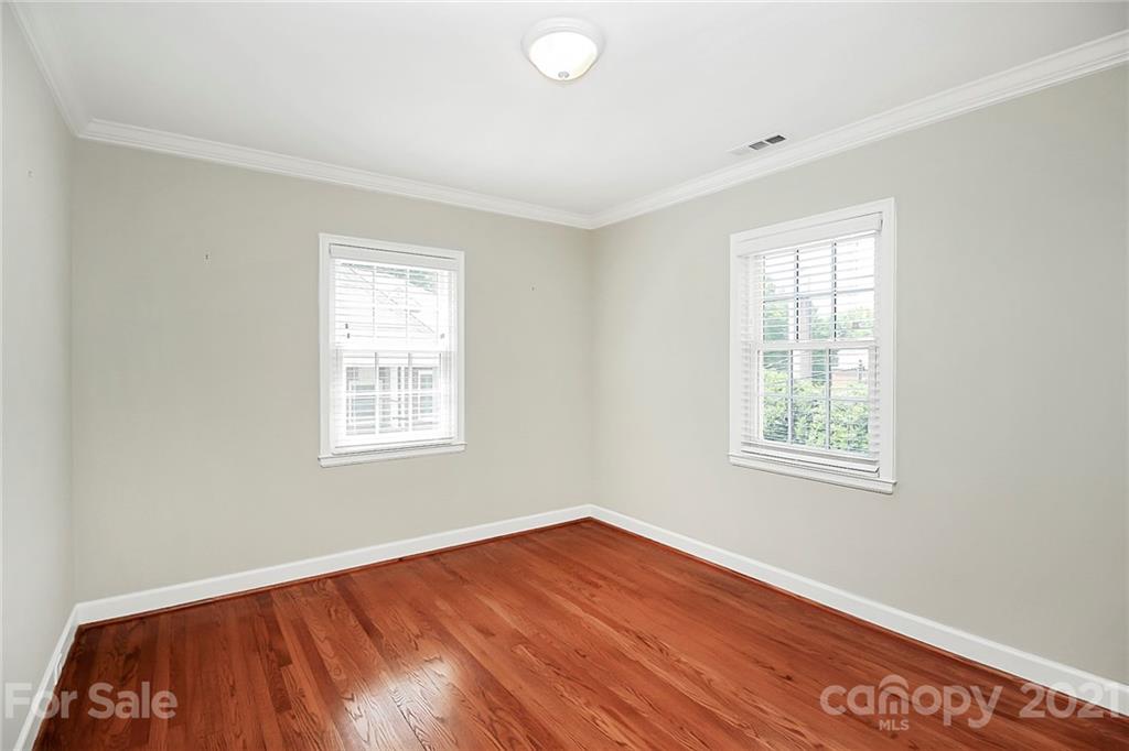 930 Ardsley Road, Unit B4 Charlotte, NC 28207 - Photo 31 of 35 a view of an empty room with wooden floor and a window