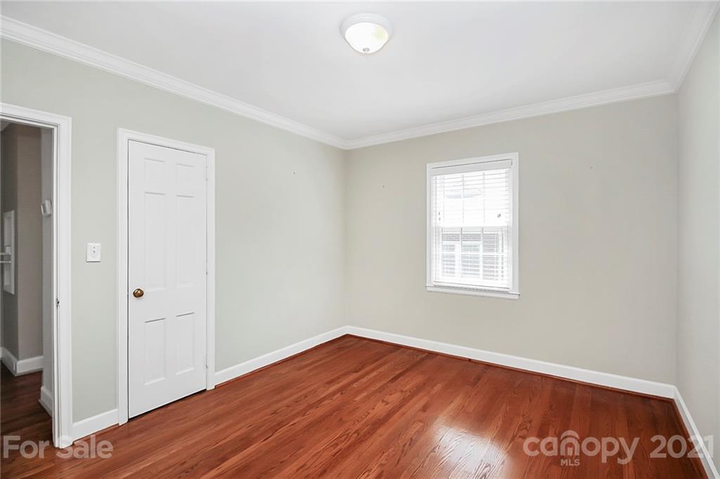 930 Ardsley Road, Unit B4 Charlotte, NC 28207 - Photo 32 of 35 an empty room with wooden floor and windows