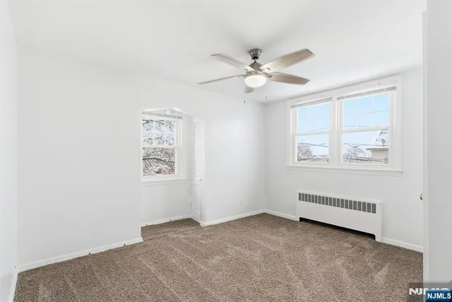 a view of room with window and ceiling fan
