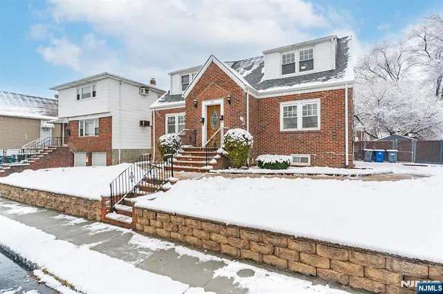 a view of a house with snow on the road
