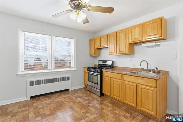 a kitchen with stainless steel appliances granite countertop a sink and cabinets