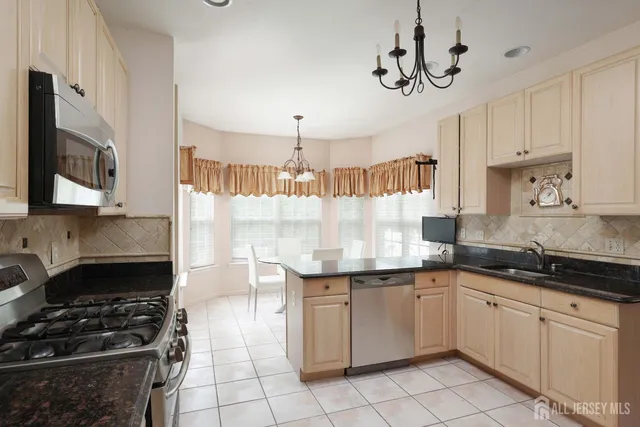 a kitchen with a stove sink and cabinets