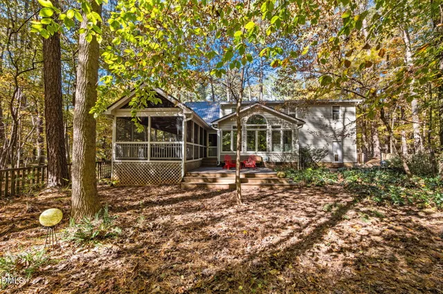 a view of a house with a small yard and wooden fence