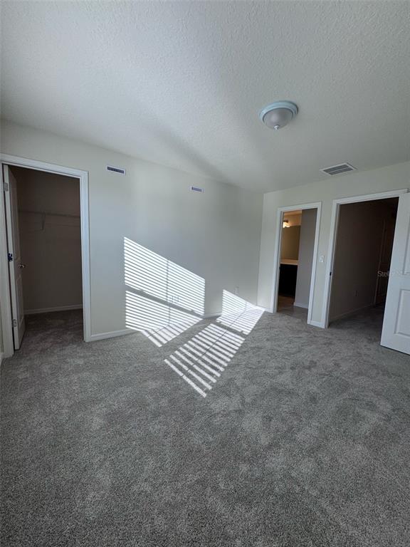 2710 Fetching Trail Davenport, FL 33896 - Photo 11 of 20 a view of an empty room with a fireplace