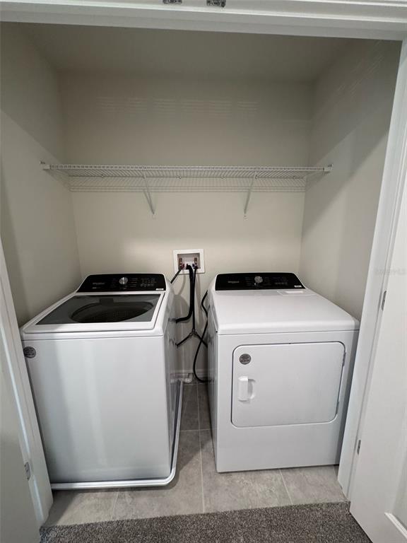 2710 Fetching Trail Davenport, FL 33896 - Photo 12 of 20 a utility room with dryer and washer