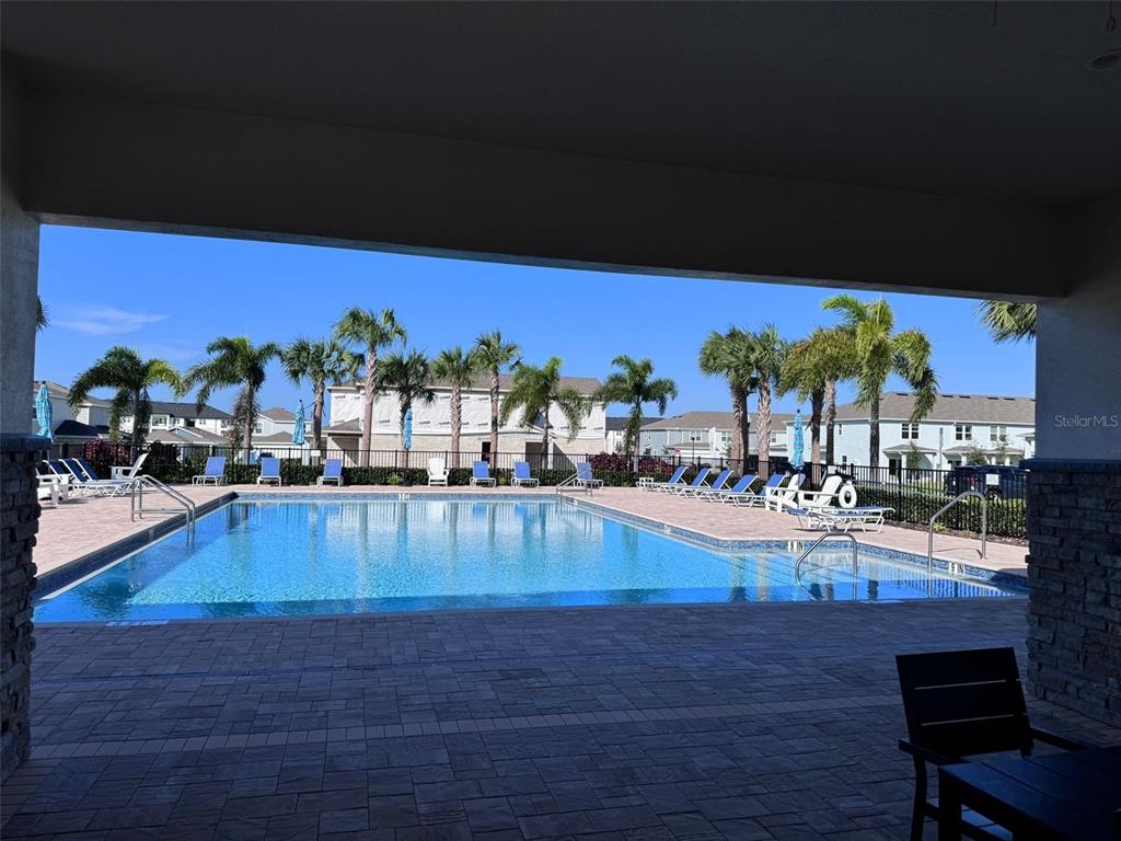 2710 Fetching Trail Davenport, FL 33896 - Photo 16 of 20 a view of a swimming pool with outdoor seating