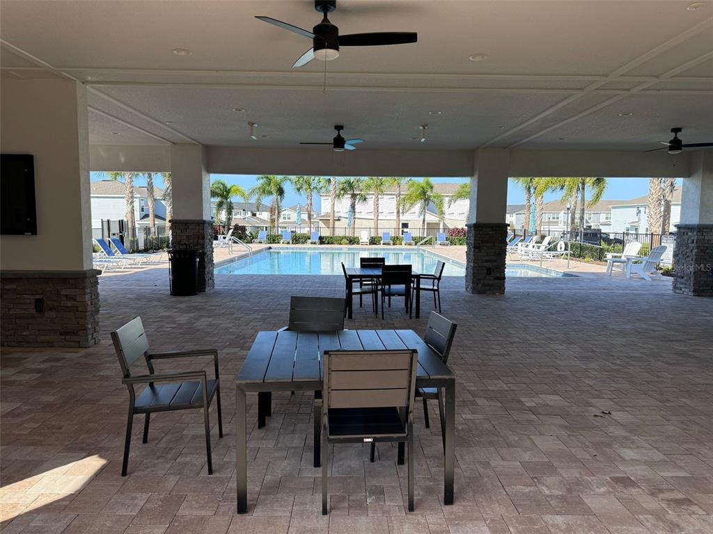 2710 Fetching Trail Davenport, FL 33896 - Photo 19 of 20 a dining room with furniture a rug and a large window