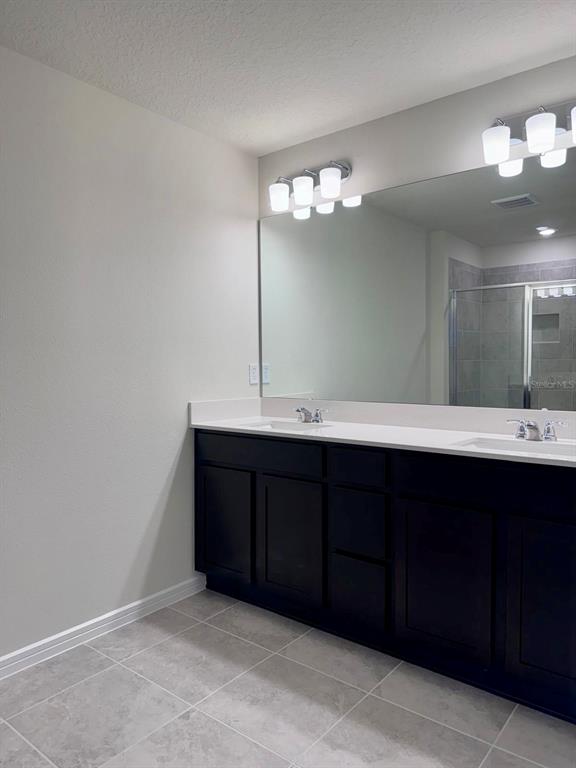2710 Fetching Trail Davenport, FL 33896 - Photo 8 of 20 a bathroom with a sink vanity and a mirror