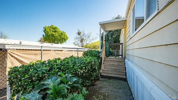 a view of a pathway of a house with a small yard
