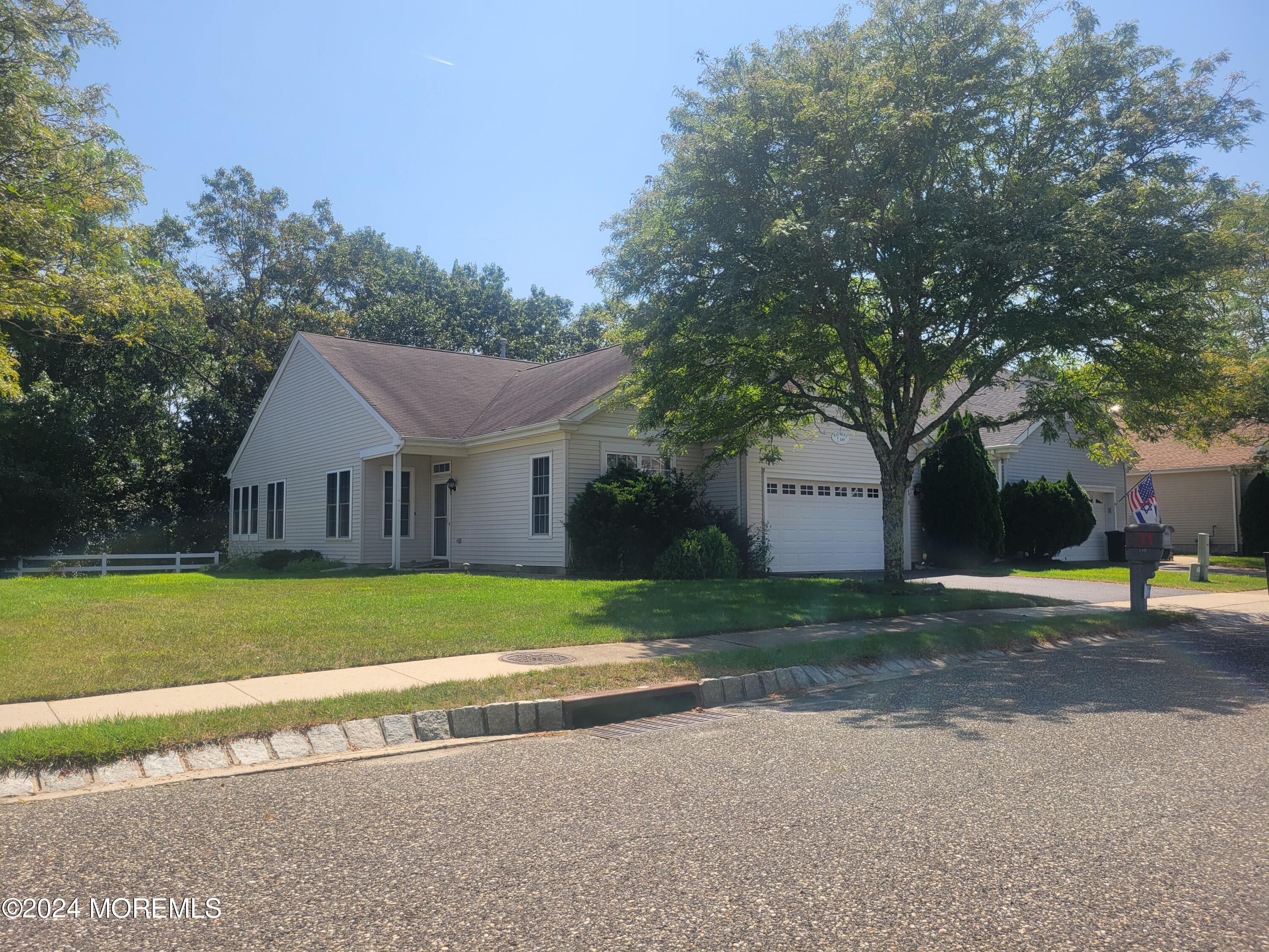 149 Sandpiper Road Barnegat, NJ 08005 - Photo 18 of 18 a view of a house next to a big yard with large trees