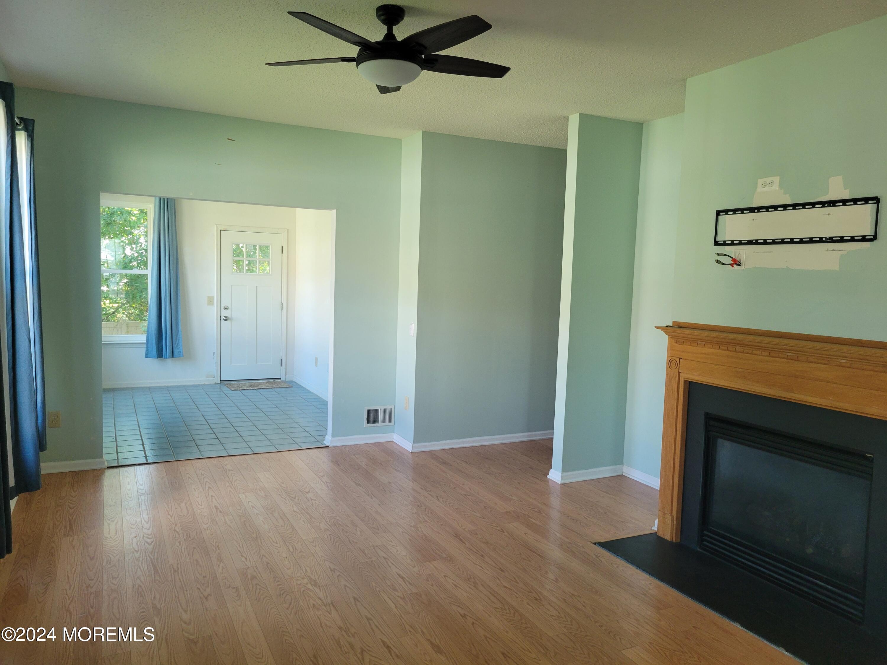 149 Sandpiper Road Barnegat, NJ 08005 - Photo 5 of 18 a view of a livingroom with a fireplace and a ceiling fan