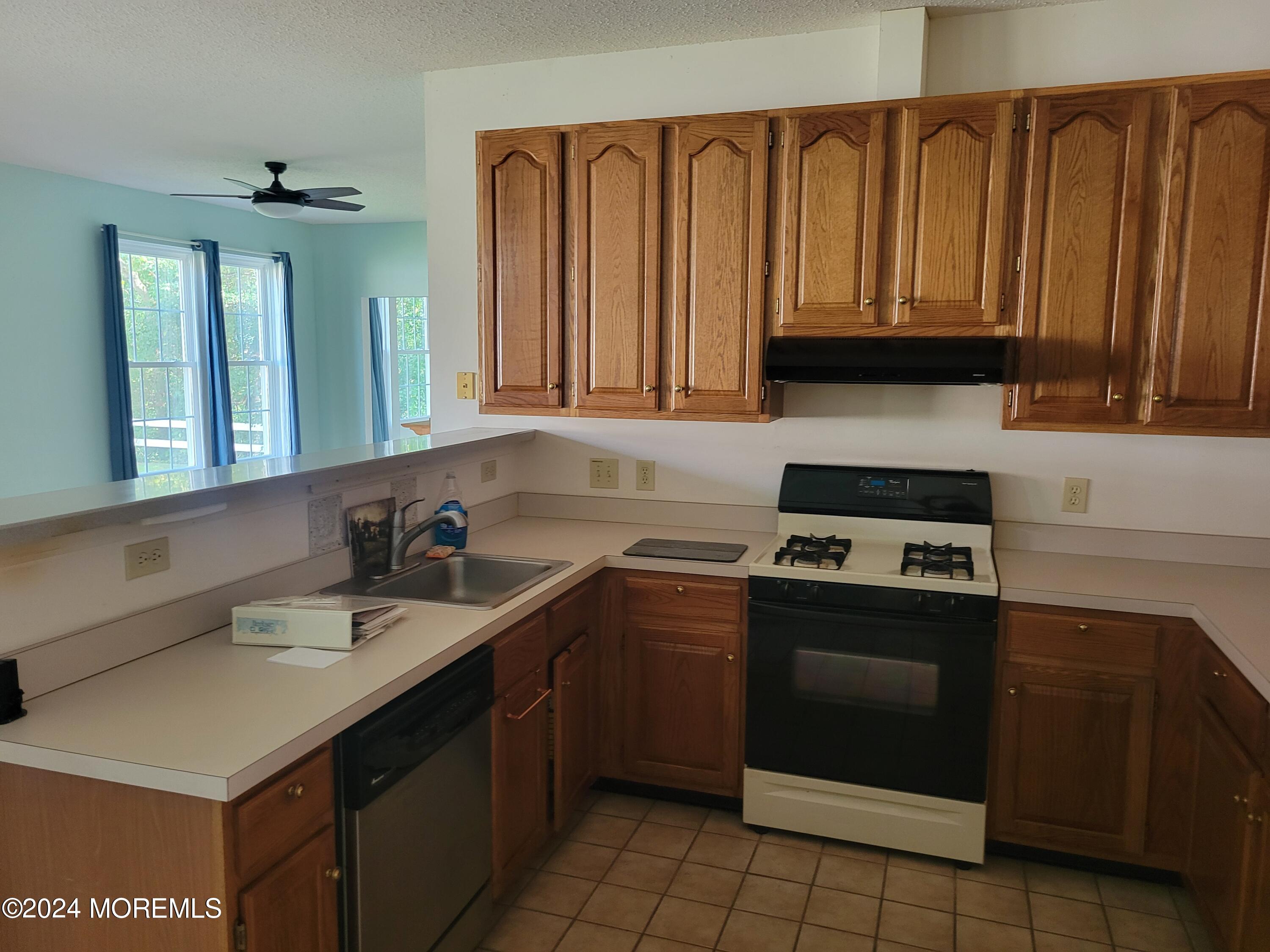149 Sandpiper Road Barnegat, NJ 08005 - Photo 6 of 18 a kitchen with a sink stove top oven and cabinets