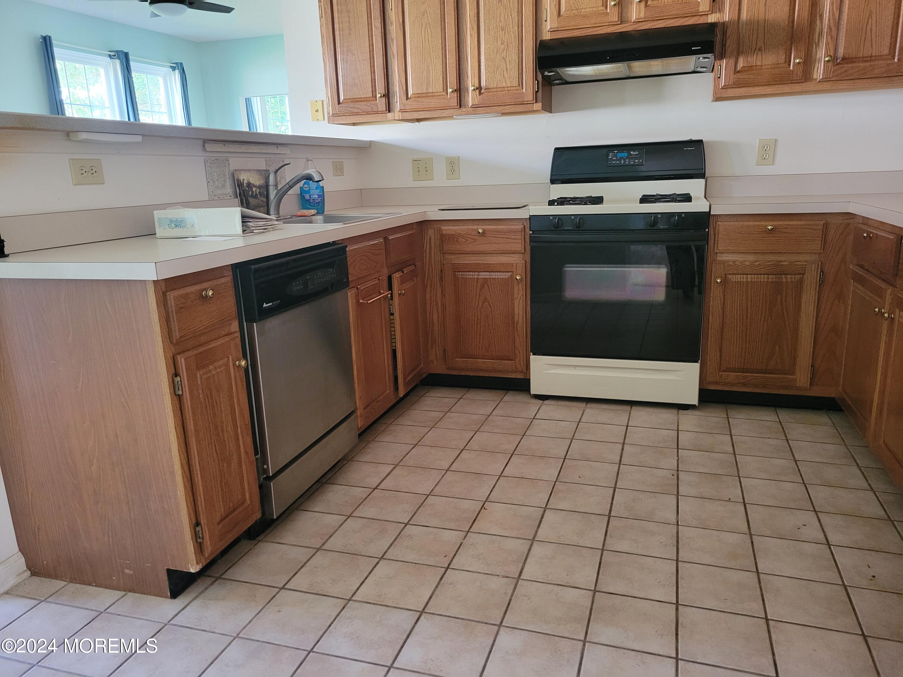 149 Sandpiper Road Barnegat, NJ 08005 - Photo 7 of 18 a kitchen with granite countertop a stove a sink and a microwave