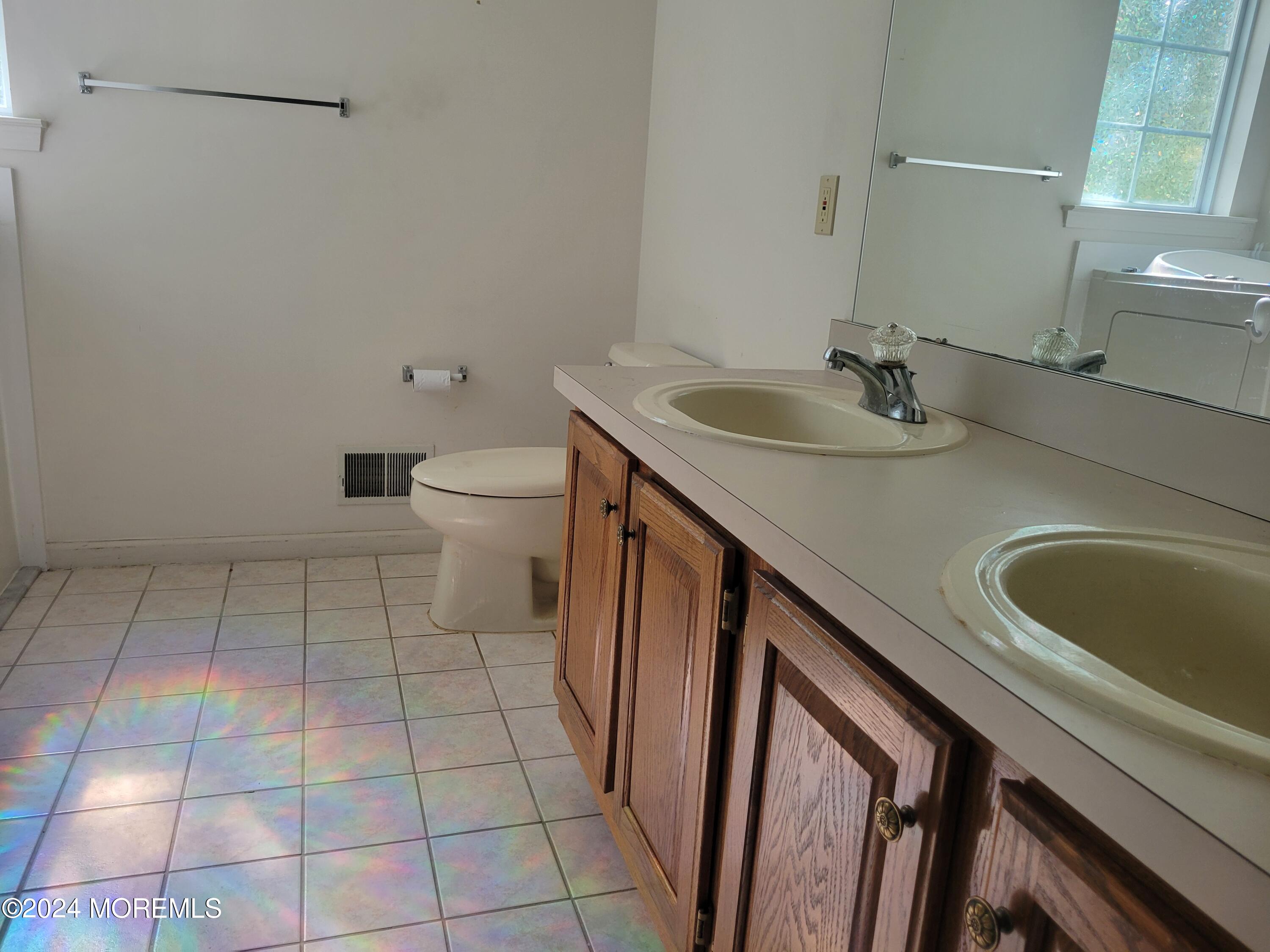149 Sandpiper Road Barnegat, NJ 08005 - Photo 9 of 18 a bathroom with a sink a toilet and a mirror