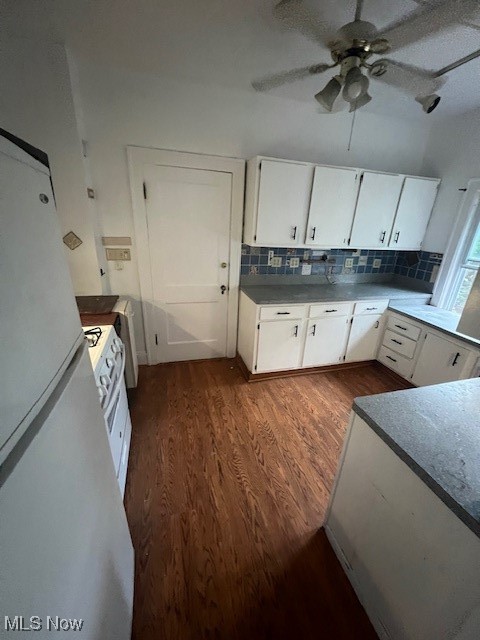 2915 Ludlow Road Cleveland, OH 44120 - Photo 22 of 50 Kitchen with white cabinets, fridge, dark wood-style flooring, decorative backsplash, and dark countertops