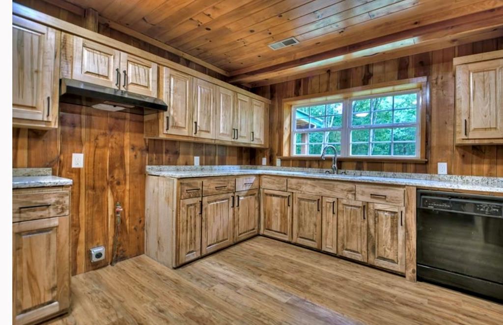 1843 Old Mobile Road McCaysville, GA 30555 - Photo 11 of 41 a kitchen with granite countertop wooden cabinets stainless steel appliances a sink and a large window
