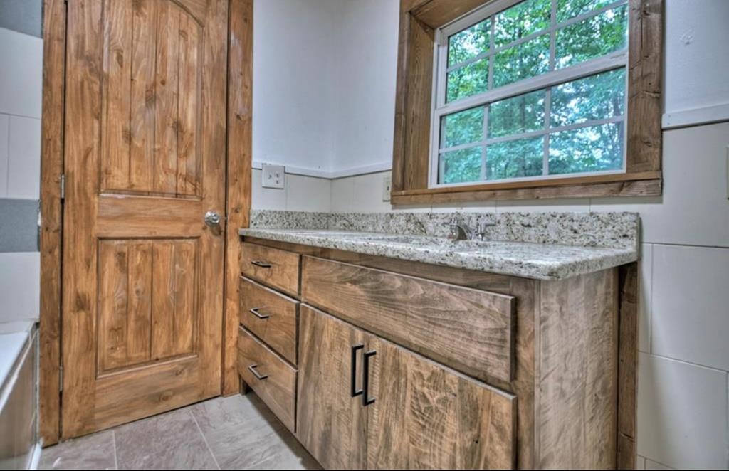 1843 Old Mobile Road McCaysville, GA 30555 - Photo 15 of 41 a bathroom with a granite countertop sink and a mirror