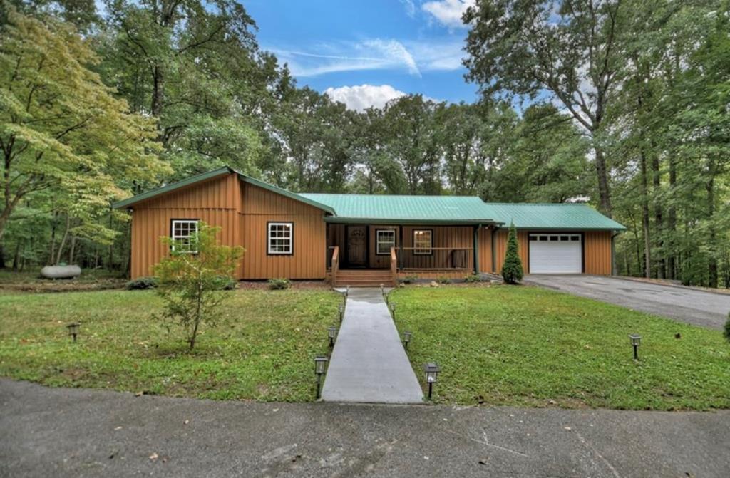 1843 Old Mobile Road McCaysville, GA 30555 - Photo 2 of 41 a view of a yard in front of a house with large trees
