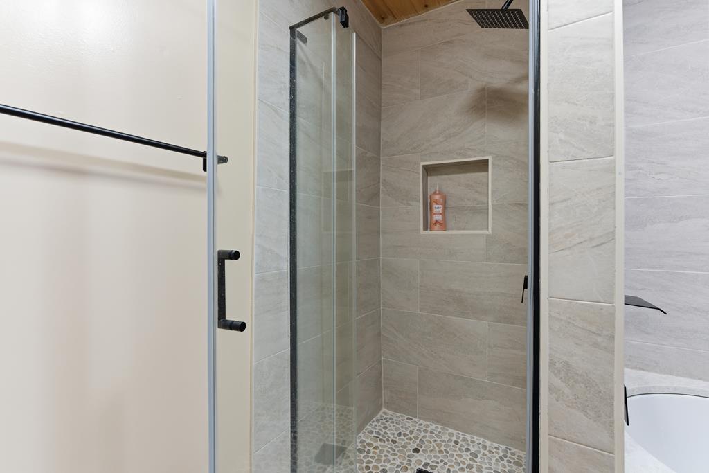 1843 Old Mobile Road McCaysville, GA 30555 - Photo 24 of 41 a bathroom with a glass shower door