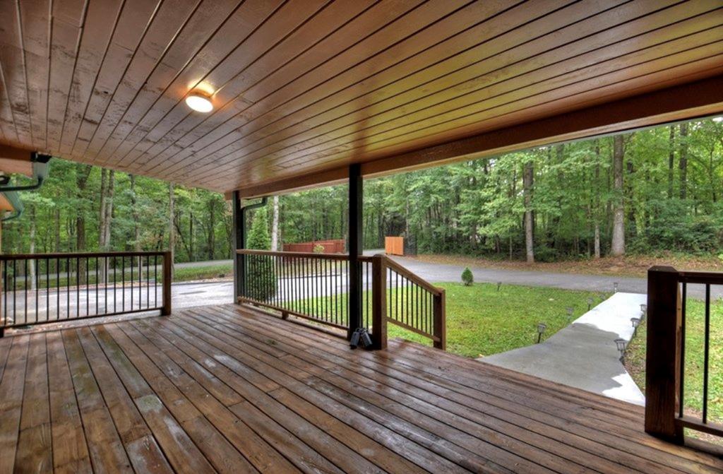 1843 Old Mobile Road McCaysville, GA 30555 - Photo 3 of 41 a view of a deck with wooden floor and roof with a garden view