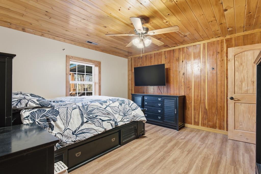 1843 Old Mobile Road McCaysville, GA 30555 - Photo 33 of 41 a bedroom with a bed and a flat screen tv