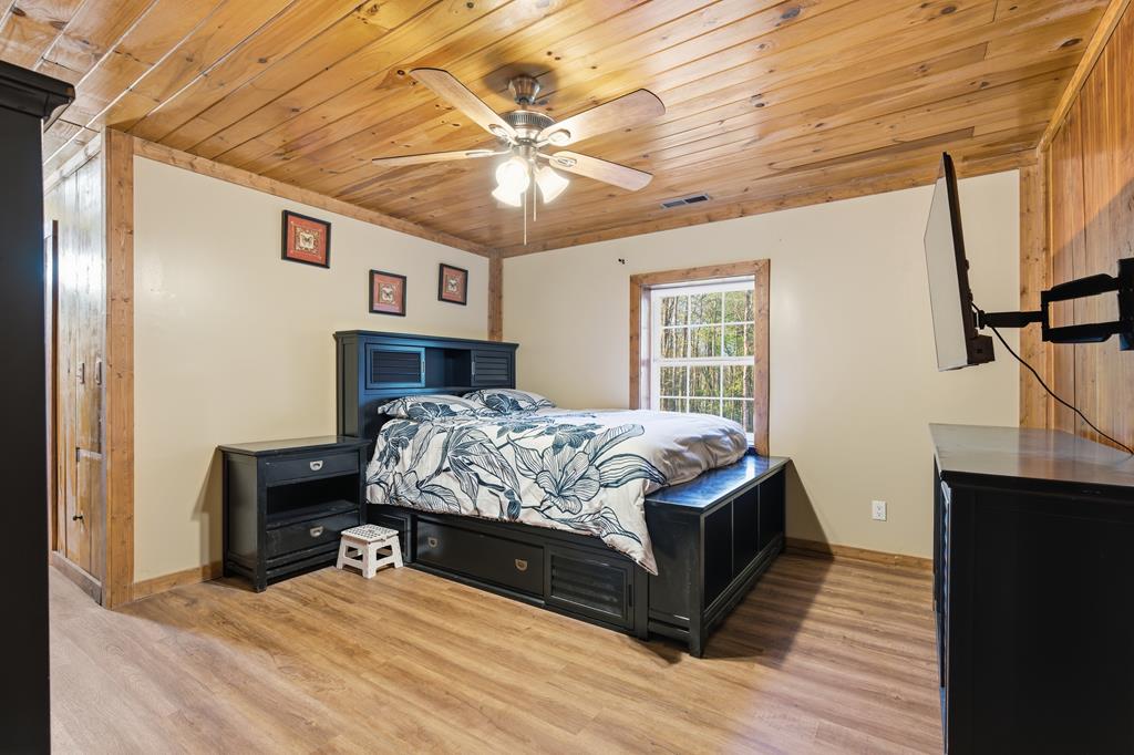 1843 Old Mobile Road McCaysville, GA 30555 - Photo 34 of 41 a bedroom with a bed and wooden floor