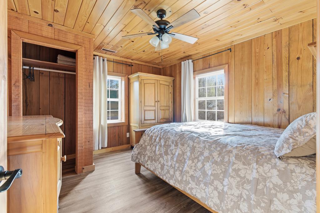 1843 Old Mobile Road McCaysville, GA 30555 - Photo 37 of 41 a bedroom with a bed and a chandelier