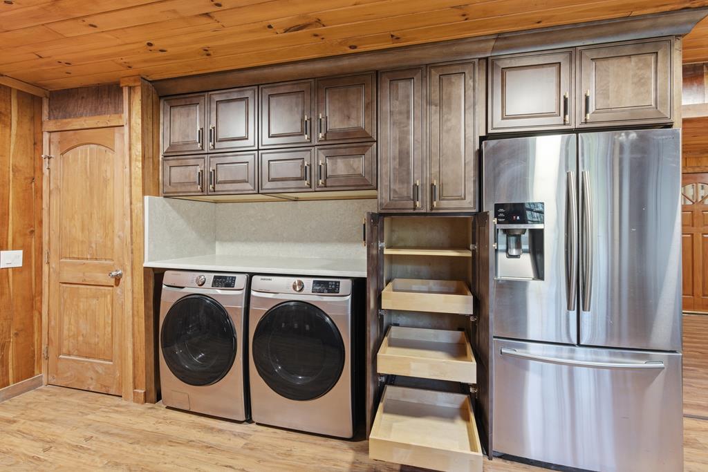 1843 Old Mobile Road McCaysville, GA 30555 - Photo 41 of 41 a kitchen with stainless steel appliances granite countertop a refrigerator a washer and dryer