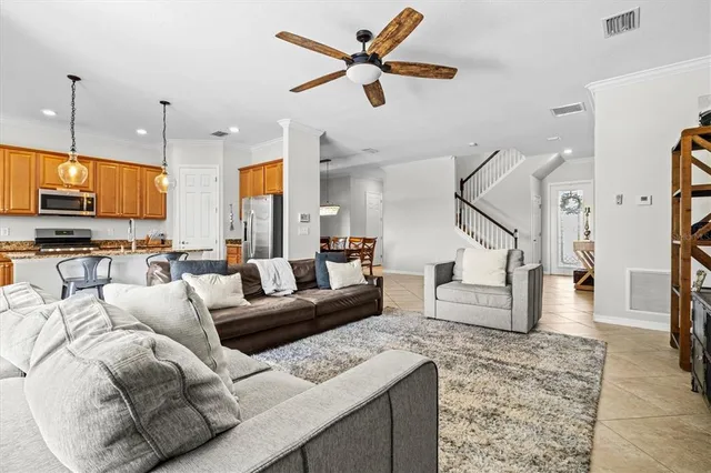 a living room with furniture a flat screen tv and a window