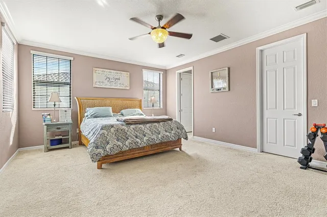 a bathroom with a granite countertop double vanity sink mirror and toilet