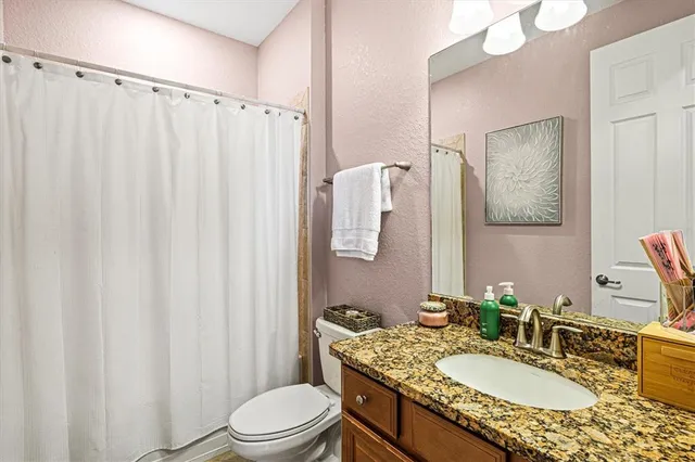 a open kitchen with stainless steel appliances granite countertop a stove and a large window