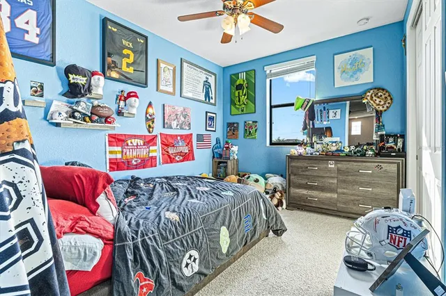 a view of swimming pool with a yard and palm trees