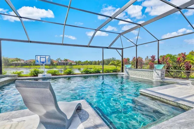 an aerial view of residential houses with outdoor space and river