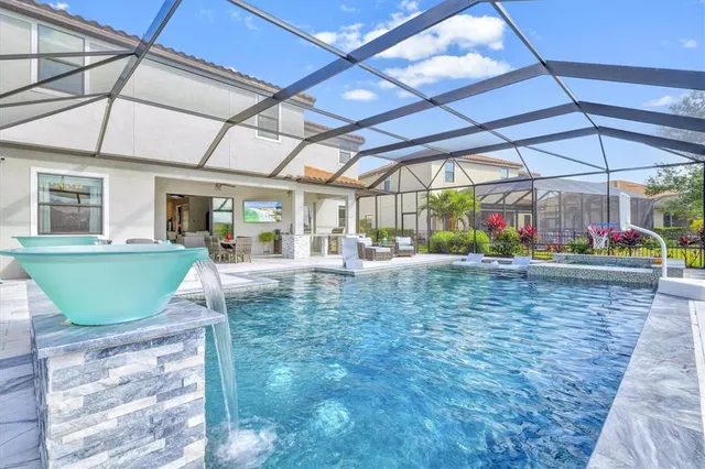 a view of a swimming pool with an outdoor space and seating area