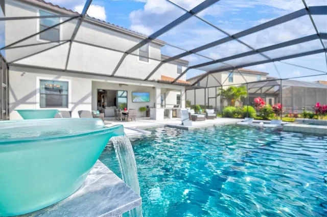 a view of a house with a swimming pool and a yard