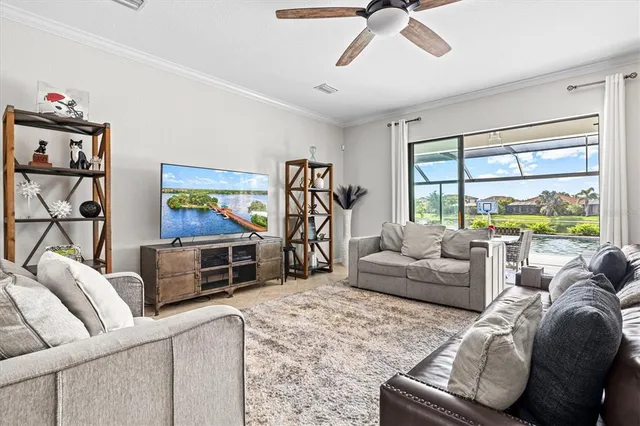 a living room with furniture kitchen view and a large window