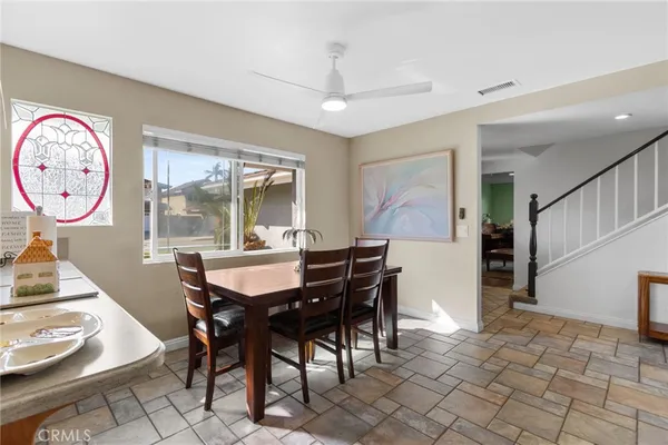 a dinning area with furniture and a large window