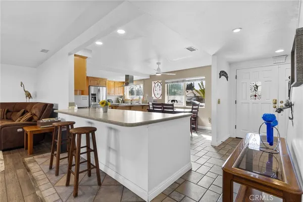 a kitchen with stainless steel appliances kitchen island granite countertop a sink and cabinets