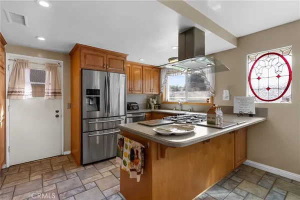 a kitchen with a appliances a stove a refrigerator and a cabinets