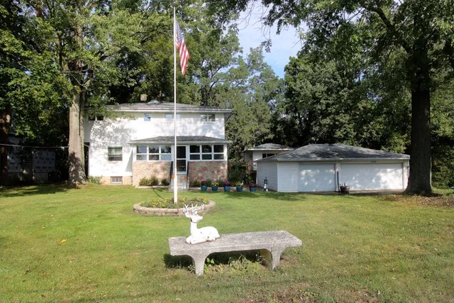 a view of a house with a yard porch and sitting area