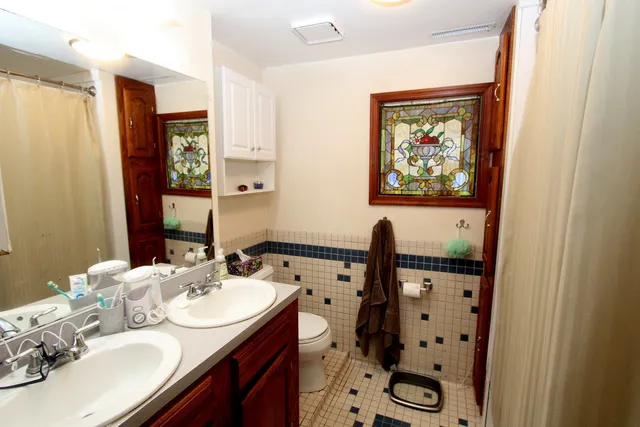 a bathroom with a sink mirror and vanity