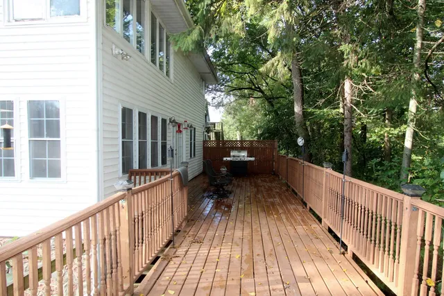 a view of balcony with wooden floor and fence