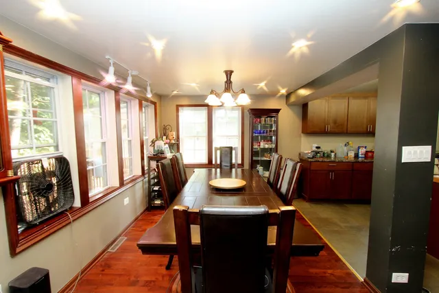 a view of a dining room with furniture and wooden floor
