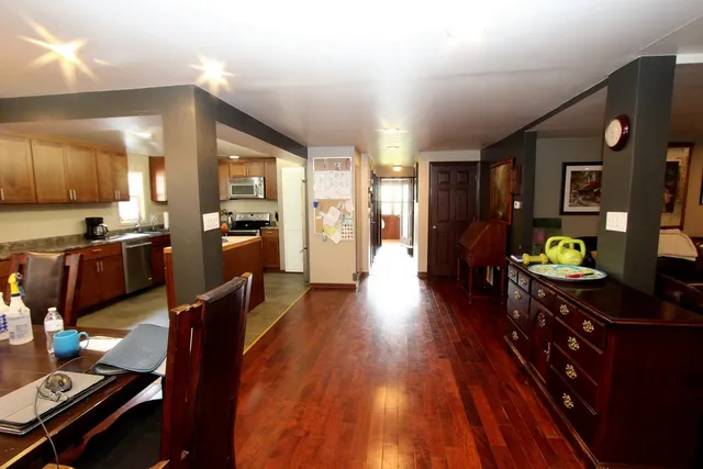 a kitchen with wooden floors and wooden cabinets