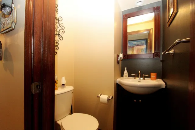 a bathroom with sink toilet and mirror