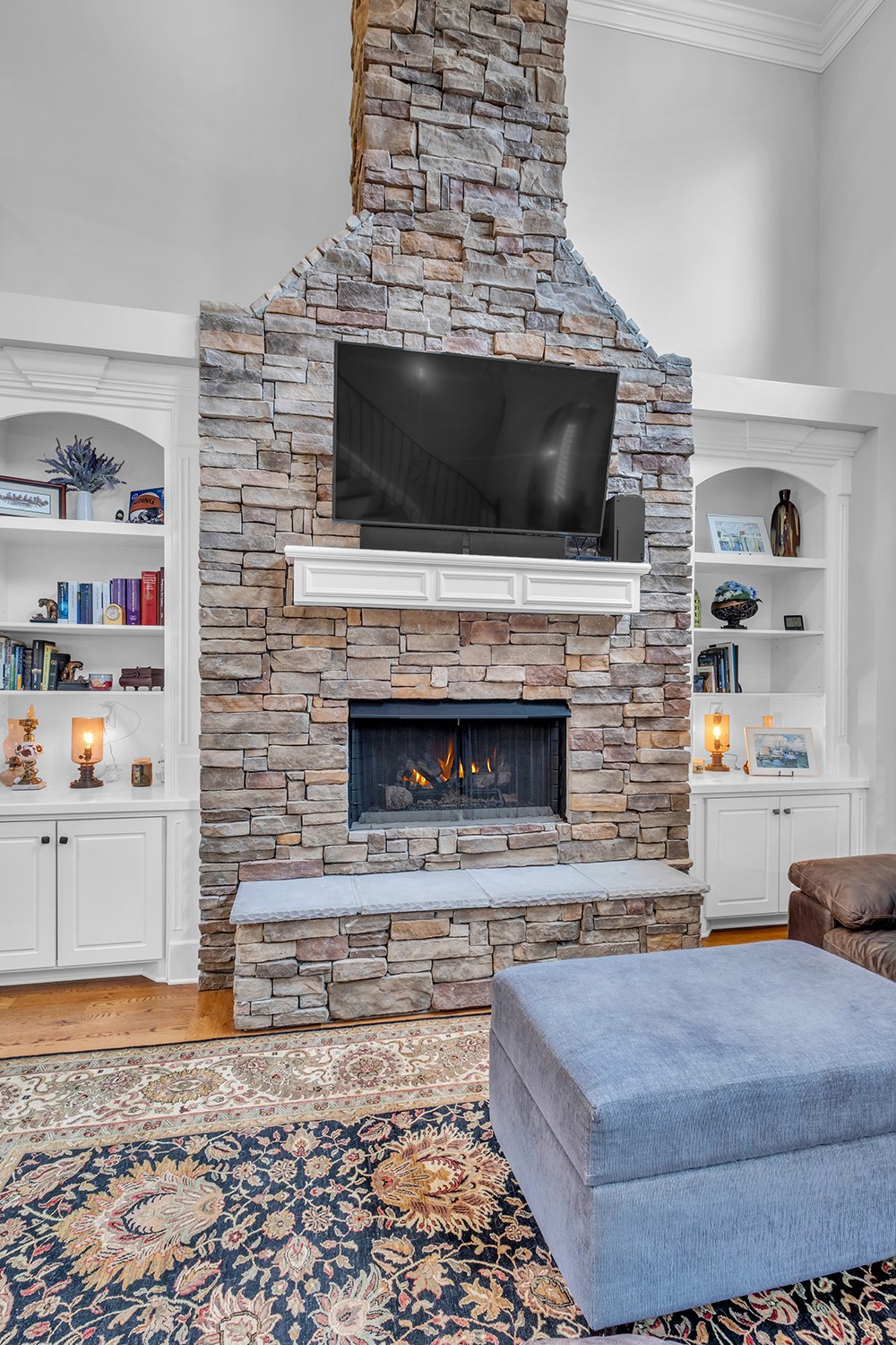 5210 Old Harding Road Franklin, TN 37064 - Photo 13 of 65 a living room with a fireplace and a flat screen tv