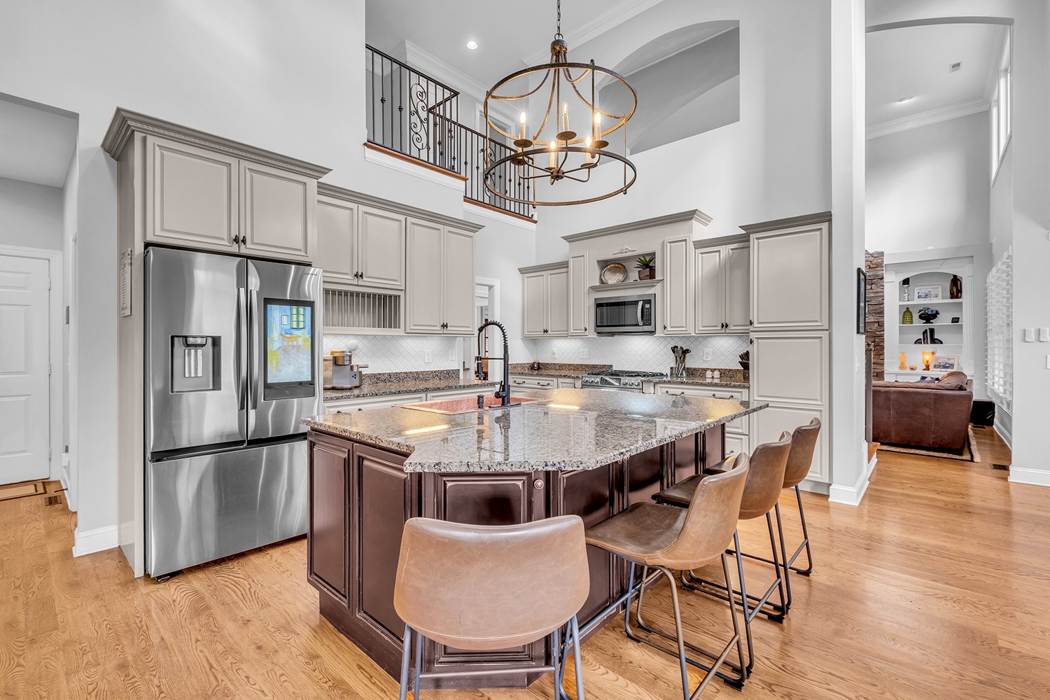 5210 Old Harding Road Franklin, TN 37064 - Photo 18 of 65 a kitchen with stainless steel appliances granite countertop a dining table chairs refrigerator and microwave